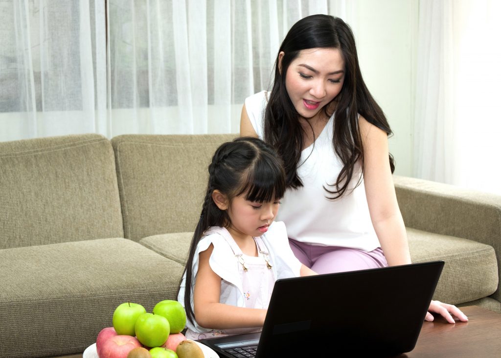 Kid learning Spanish at home with her mum